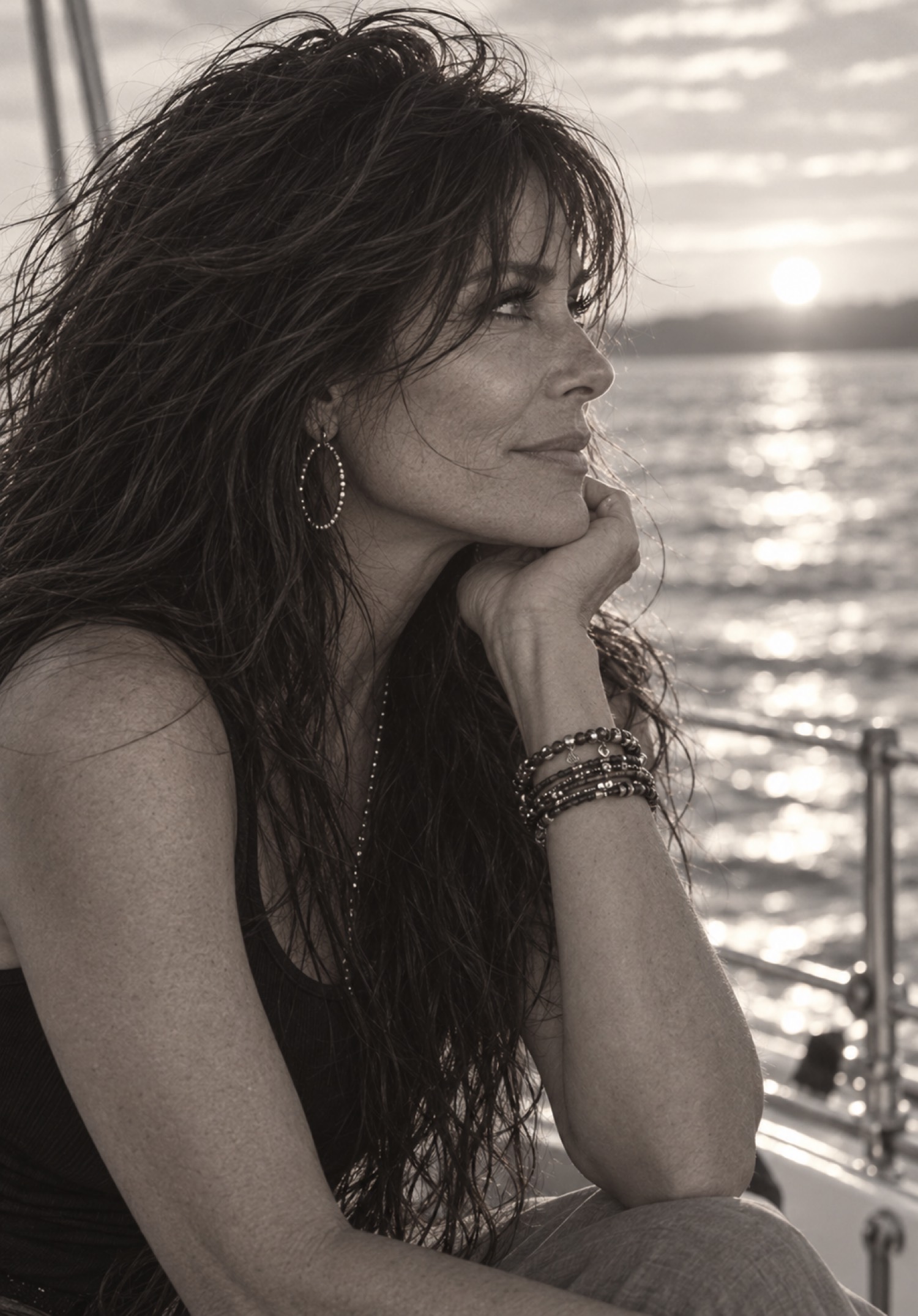 Maureen Steele on the water at sunset, chin resting on her hand.