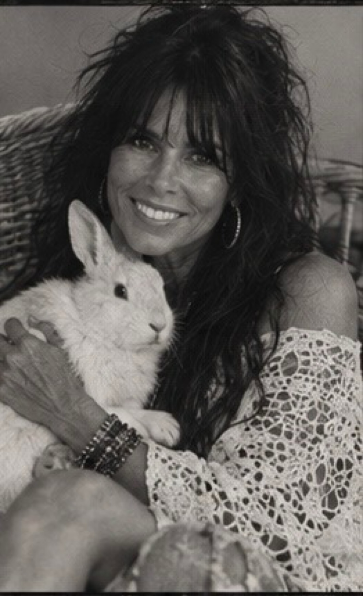 Maureen Steele with a white rabbit, in black and white.